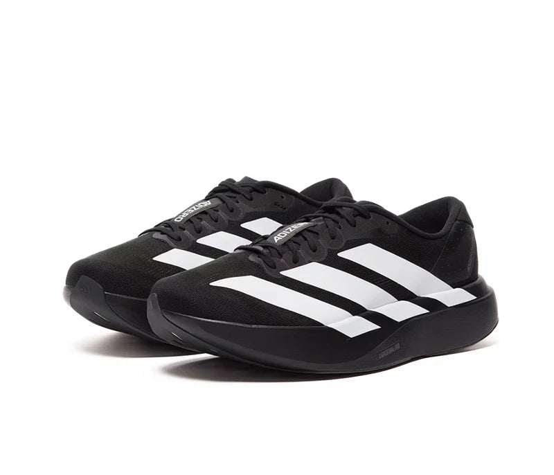 Black athletic shoes with white stripes on a white background