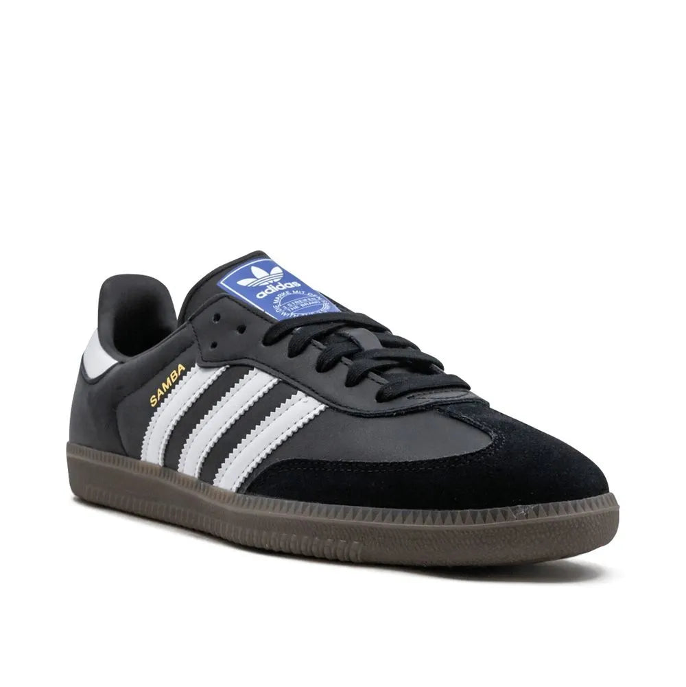 Black Adidas sneaker with white stripes on a white background