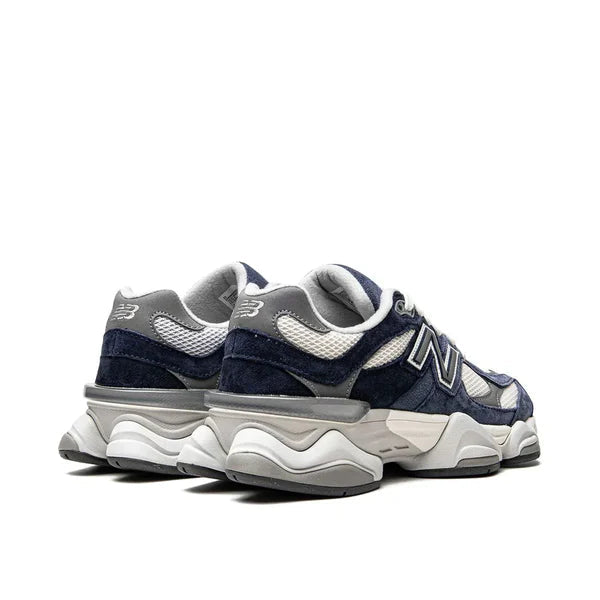 Pair of navy and white sneakers on a white background