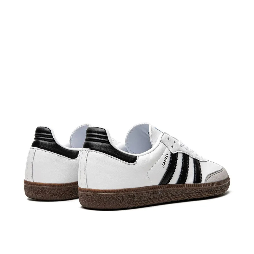White adidas samba sneakers with black stripes on a white background